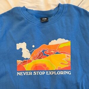 The North Face Blue Sweatshirt with Vibrant Graphic